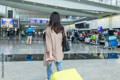 Back view of woman go travel in airport