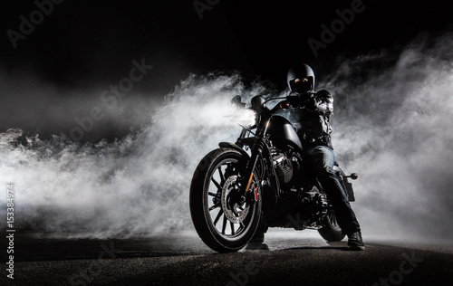 High power motorcycle chopper with man rider at night