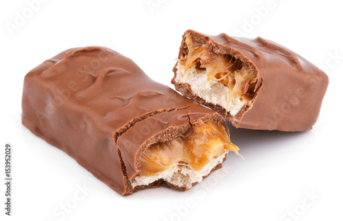 Closeup of broken chocolate bar (nougat topped with caramel, enrobed in milk chocolate) isolated on white background