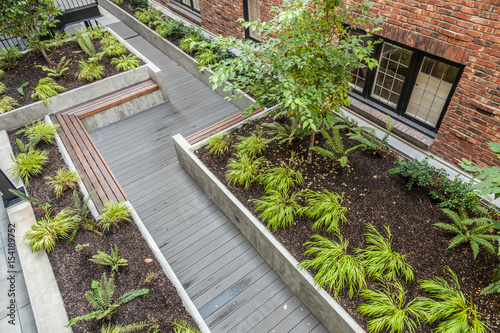 courtyard garden with benches and wooden walkway