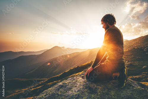 Man relaxing at sunset mountains Travel Lifestyle spiritual awakening emotional meditating concept vacations outdoor harmony with nature landscape