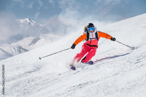 Female skier on a slope in the mountains