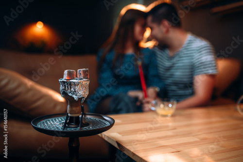 Young couple relax and smoking hookah