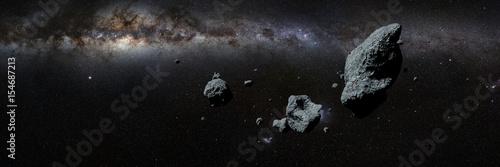 a swarm of asteroids in front of the Milky Way galaxy