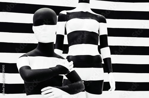 Art mannequin black and white stripes, on striped with black and white stripes. Disguise.