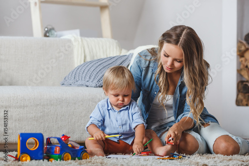 cute mother and child boy play together indoors at home