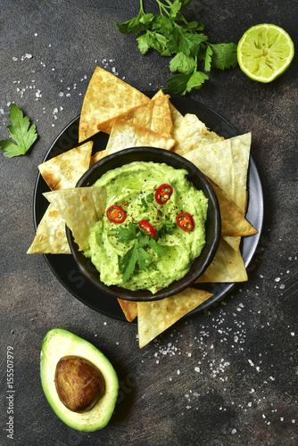 Avocado dip guacamole with tortilla chips.Top view.