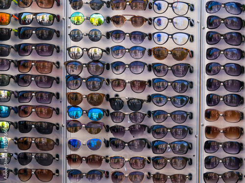 many different sunglasses in a store on the market