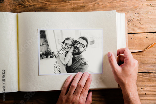 Fathers day concept. Photo album, black-and-white pictures.