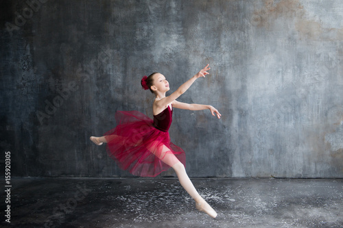 girl ballerina in red tutu doing exercise