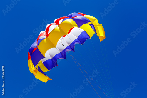 The colorful parachute in the blue sky