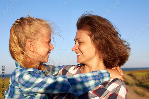 Parent and child smile, enjoy life and looking to camera. Closeup.