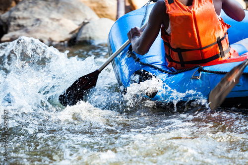 Close-up of young person rafting on the river, extreme and fun sport at tourist attraction