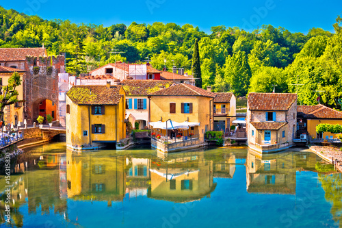 Mincio river and idyllic village of Borghetto view