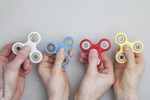 Hands holding popular fidget spinner toy