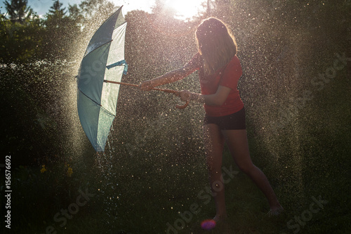 girls having fun outdoor with splashes water 