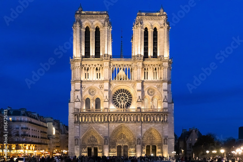 Notre-Dame de Paris Cathedral facade at dusk with illuminations
