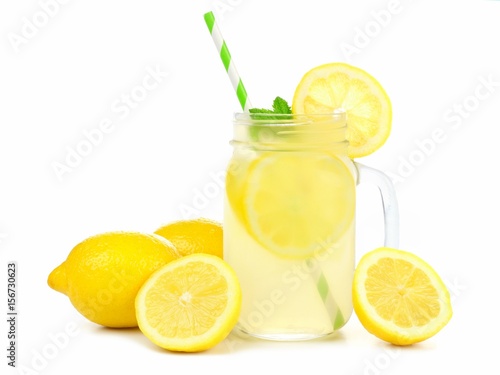 Mason jar glass of lemonade with lemons and straw isolated on a white background