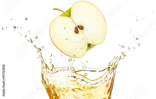 half apple falling in splashing juice isolated on white