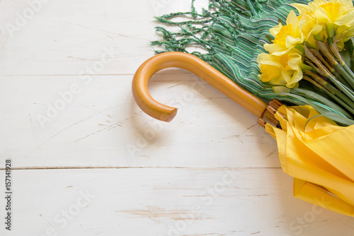 A yellow umbrella with bouquet of yellow flowers