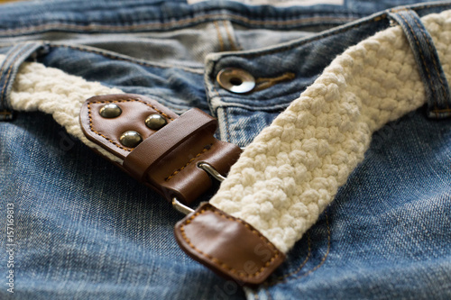 Blue jeans and white woven belt. Men's casual outfits. Selective focus