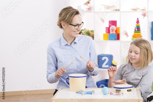 Playing toy instruments with teacher