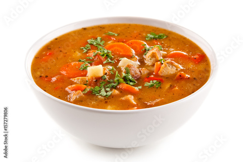 Tomato soup with carrot and chicken on white background