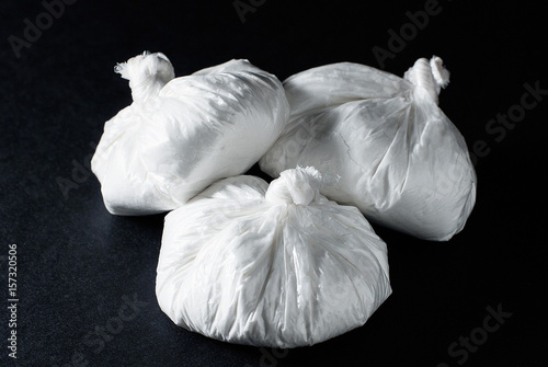 Several packets of cocaine on a black background