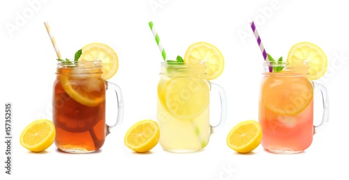 Three mason jar glasses of summer iced tea, lemonade, and pink lemonade drinks isolated on a white background