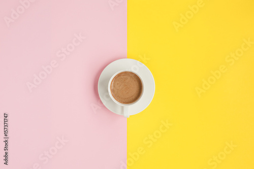 Cup of coffee on colorful surface