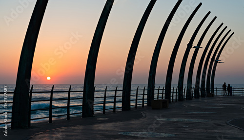 Couple viewing the Indian Ocean through the Pier in Umhlanga Rocks at Sunrise