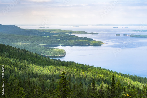 Scenic landscape with lake and lush forest at day time in Koli, national park, Finland
