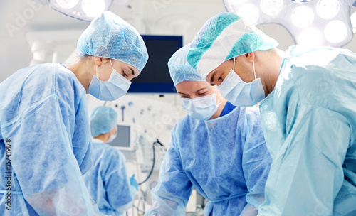 group of surgeons in operating room at hospital