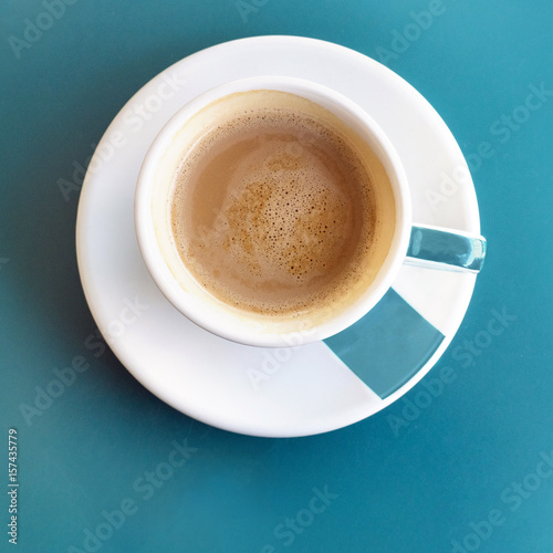 Cup of coffee on turquoise with copyspace