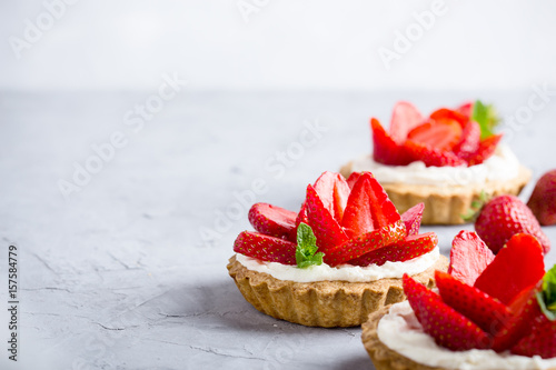 Strawberry vanilla cream cheese tarts over light gray table