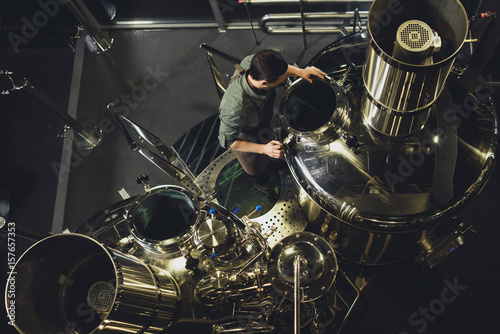 Brewer inspecting tank