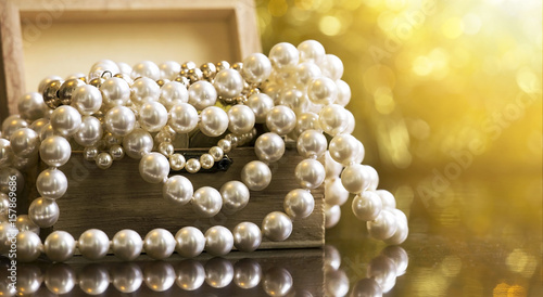 Website banner of white and golden pearls jewelry in a wooden box