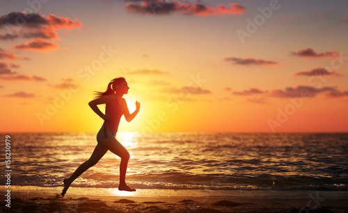 Runner Woman Running In The Beach At Sunset 