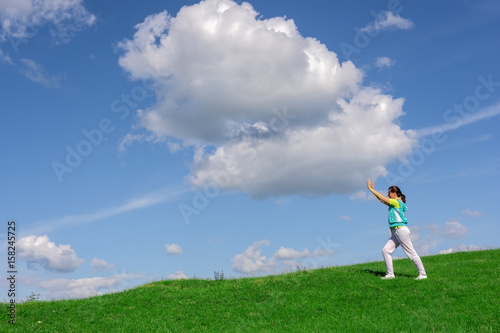 Woman pushes big cloud in the sky