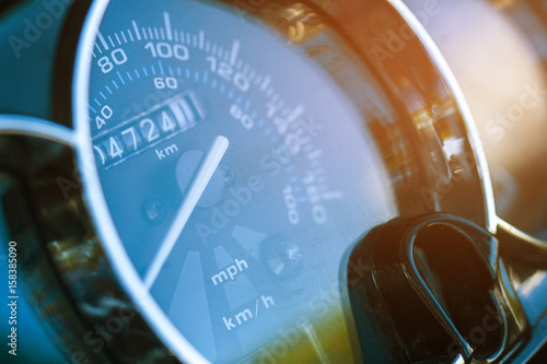 Round speedometer macro. The white arrow on the speedometer. The odometer