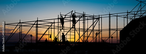 Construction workers working on scaffolding.