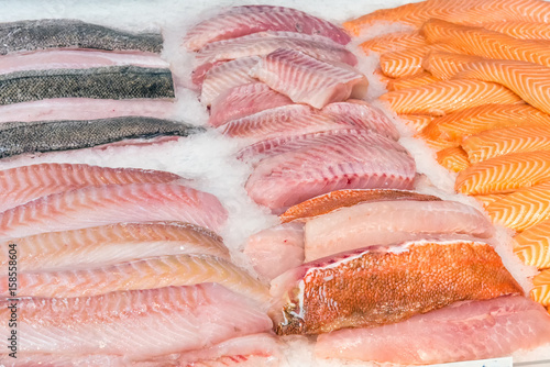 Fresh fish fillets on ice for sale at a market