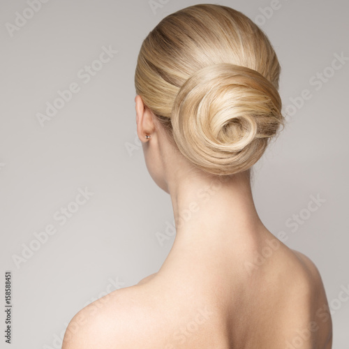 Portrait Of A Beautiful Young Blond Woman With Bun Hairstyle.