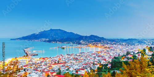 Zante - Zakinthos islnad, capital city, view from above, twilight scenery, panoramic aspect ratio photography. Zante is famous and popular summer resort. Greece, EU country.