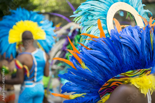 Group of dancers wearing colorful feathers costumes gathered for a gay pride street parade