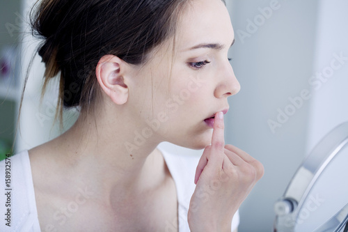 Woman looking at herself in the mirror