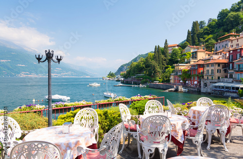 restaurant terrace with view of beautiful Varenna old town, Lake Como, Italy
