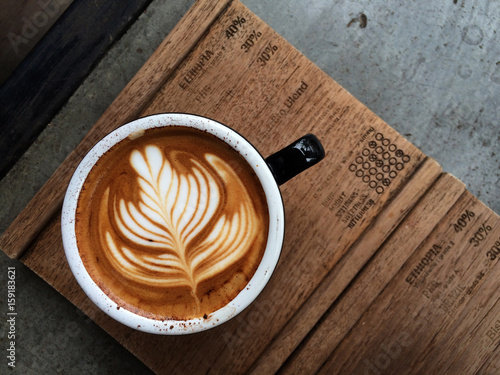 Nice Texture of Latte art on hot latte coffee . Milk foam in heart shape leaf tree on top of latte art from professional barista artist