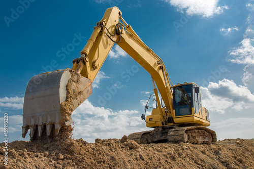 excavator blue sky heavy machine construction site