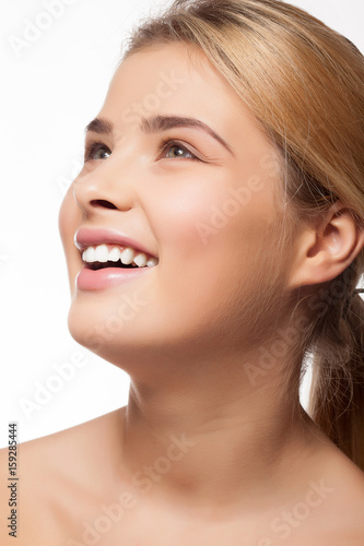 Gorgeous beautiful girl smiling on white background in studio photo. Perfect white teeth